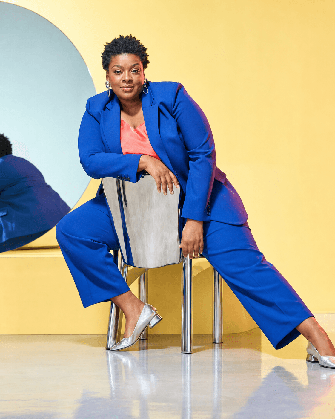 AI house model in blue suit on a chrome chair