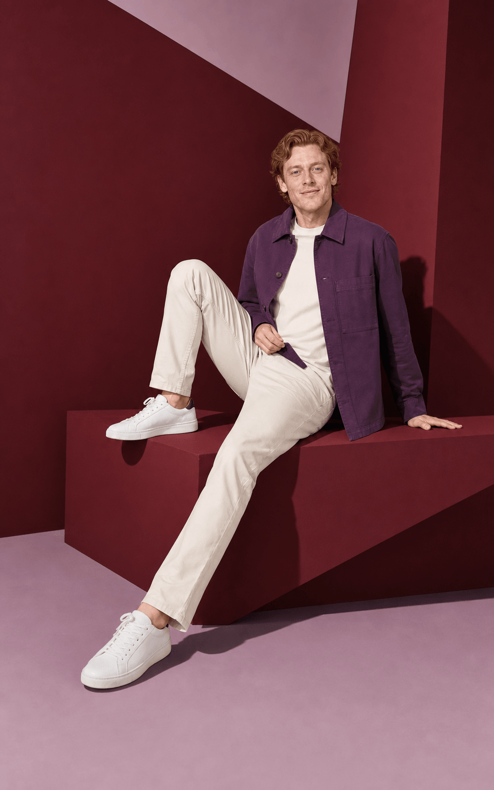 Red-haired AI house model in creative seated campaign pose