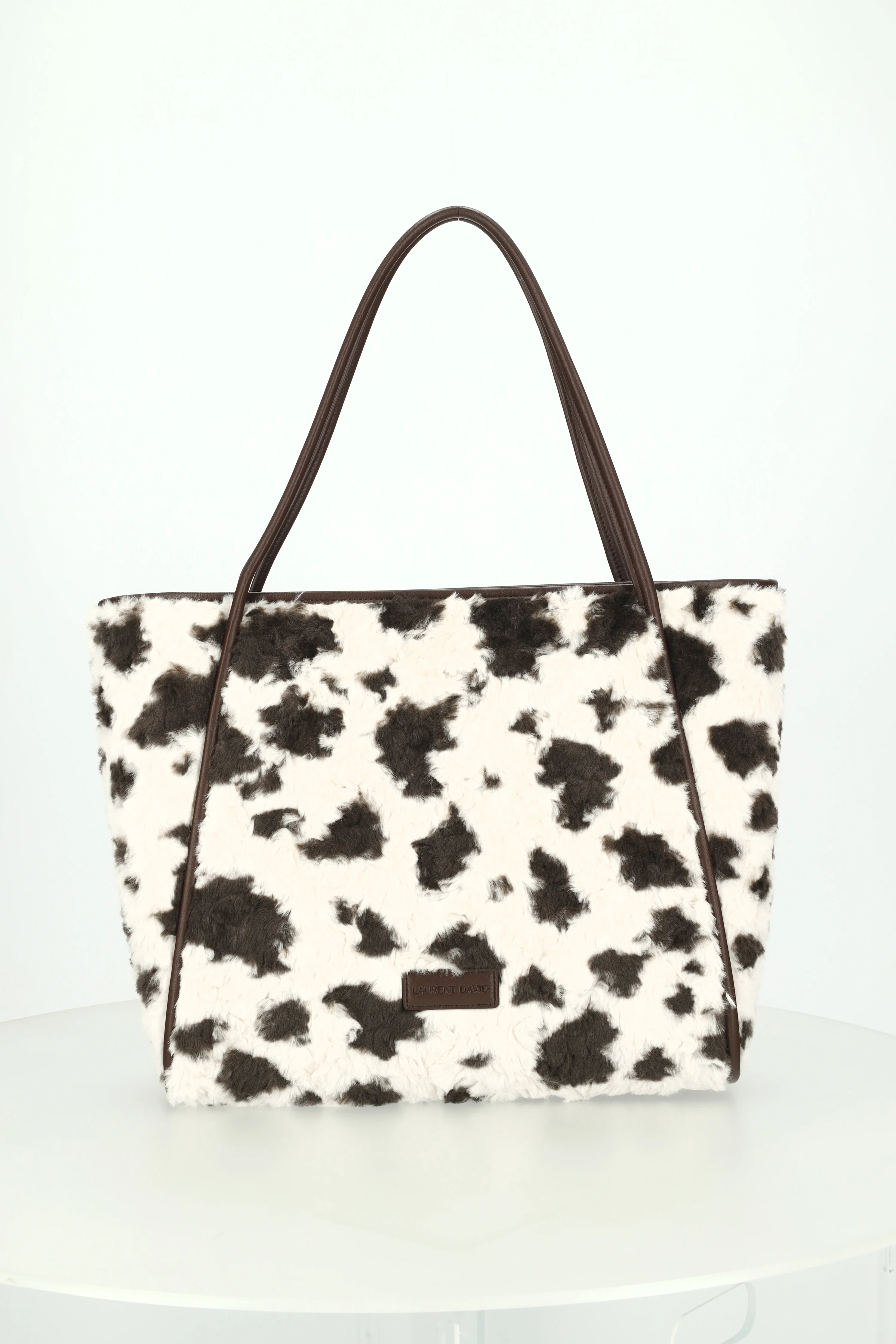 Cow print shopper on a turntable in the studio