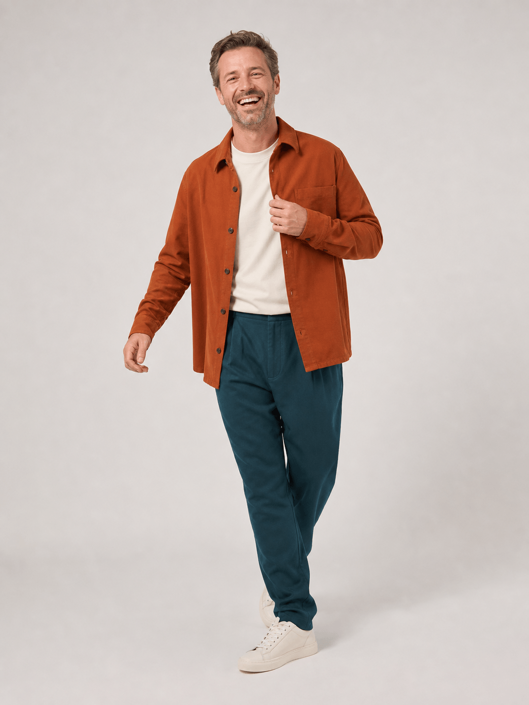 Smiling staff member in a dynamic walking pose in the photo studio