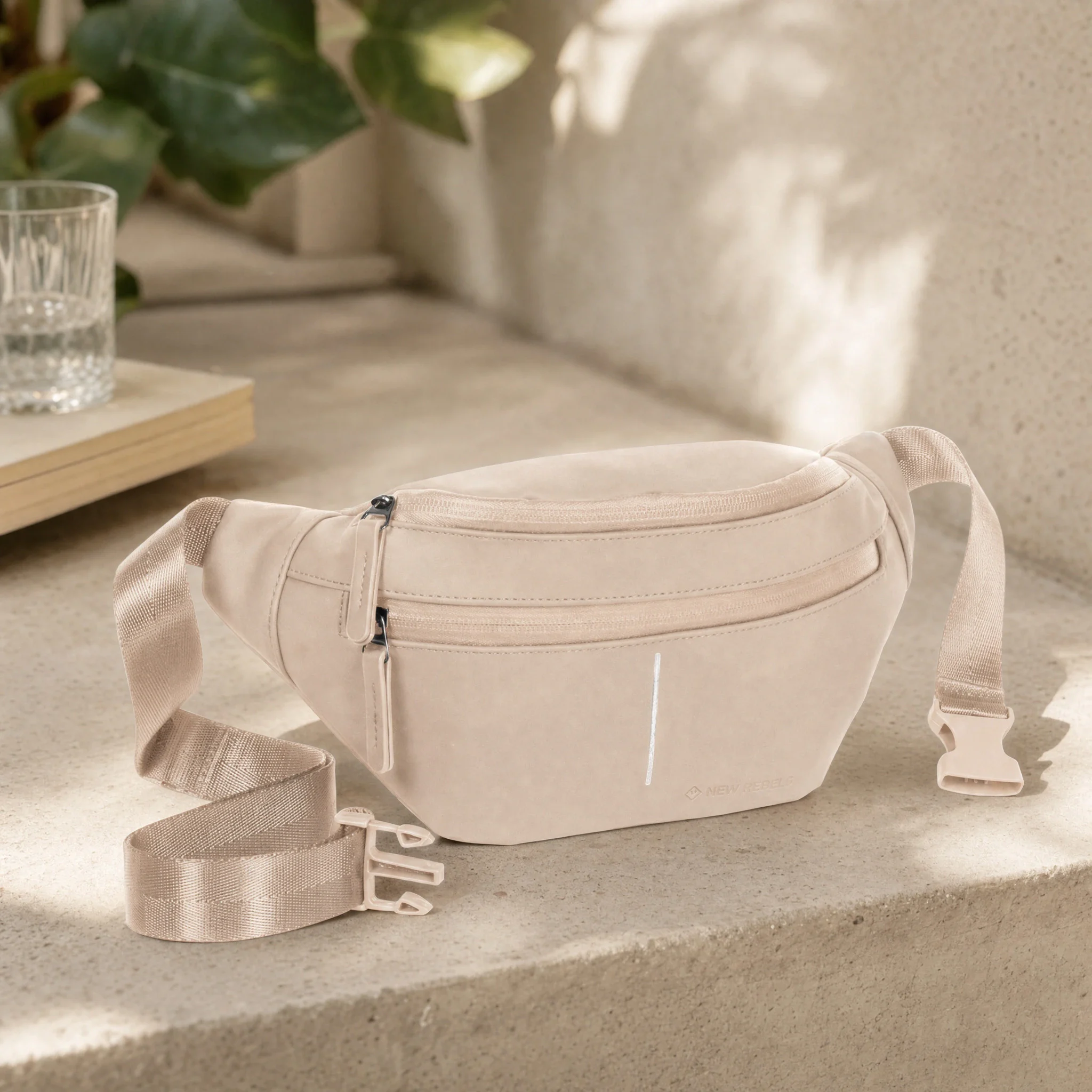 AI scene: vintage pink New Rebels waist bag on a stone bench next to a plant