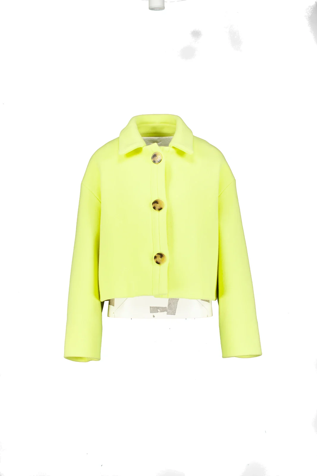 Neon yellow short jacket with horn buttons on a mannequin